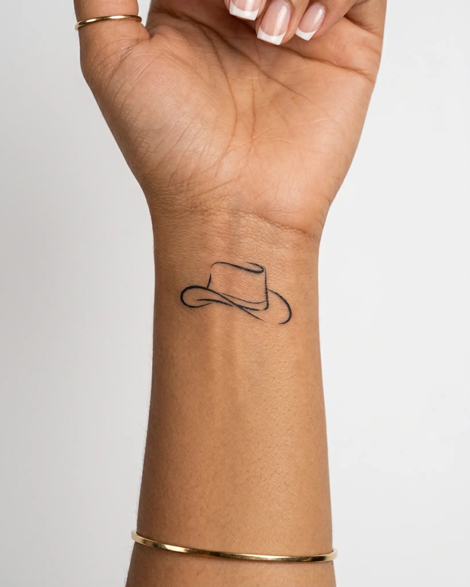 INKY Cowboy Hat semi-permanent tattoo applied on a woman – 2 x 2 in (4x4 cm) design, realistic ink look, lasts 10 days