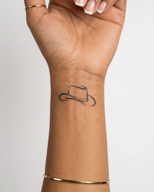 INKY Cowboy Hat semi-permanent tattoo applied on a woman – 2 x 2 in (4x4 cm) design, realistic ink look, lasts 10 days