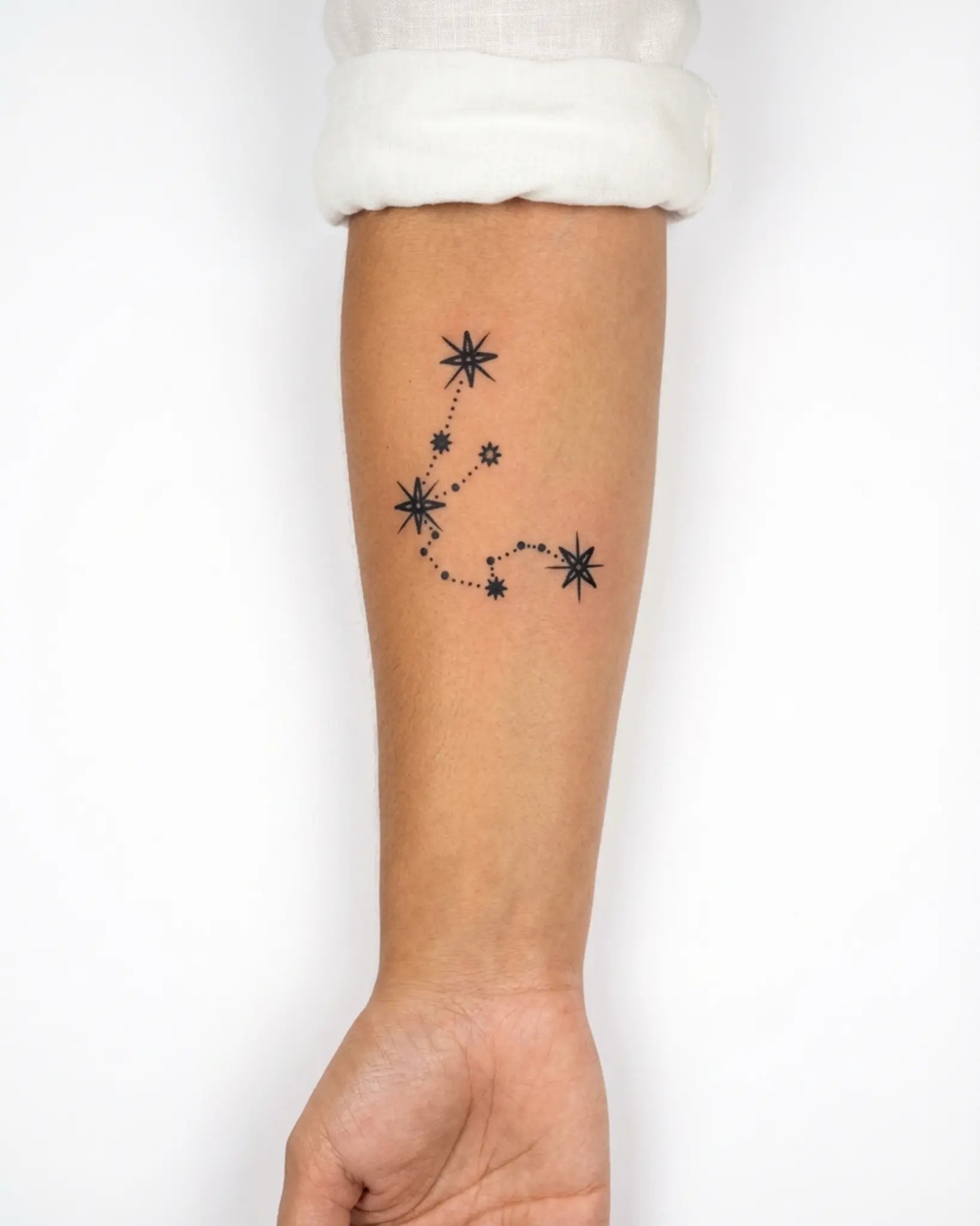 INKY Aquarius Star semi-permanent tattoo applied on a woman – 3 x 3 in (7x7 cm) design, realistic ink look, lasts 10 days