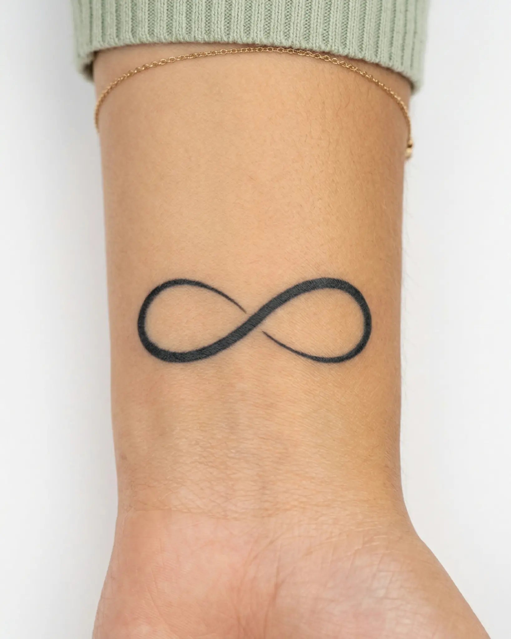 INKY Infinity semi-permanent tattoo applied on a woman – 2 x 2 in (4x4 cm) design, realistic ink look, lasts 10 days