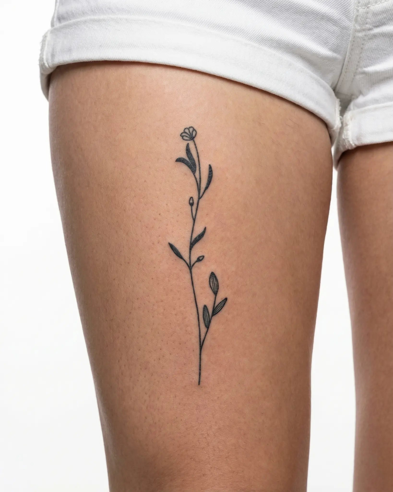INKY Floral Sprig 2 semi-permanent tattoo applied on a woman – 4 x 8 in (11x20 cm) design, realistic ink look, lasts 10 days