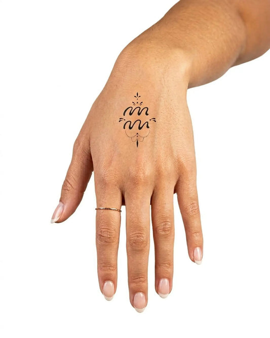 INKY Aquarian semi-permanent tattoo applied on a woman – 2 x 2 in (4x4 cm) design, realistic ink look, lasts 10 days