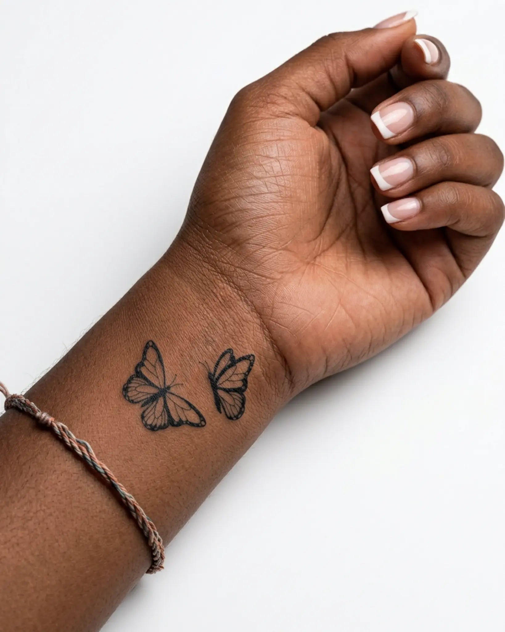 INKY Butterfly Duo semi-permanent tattoo applied on a woman – 2 x 2 in (4x4 cm) design, realistic ink look, lasts 10 days