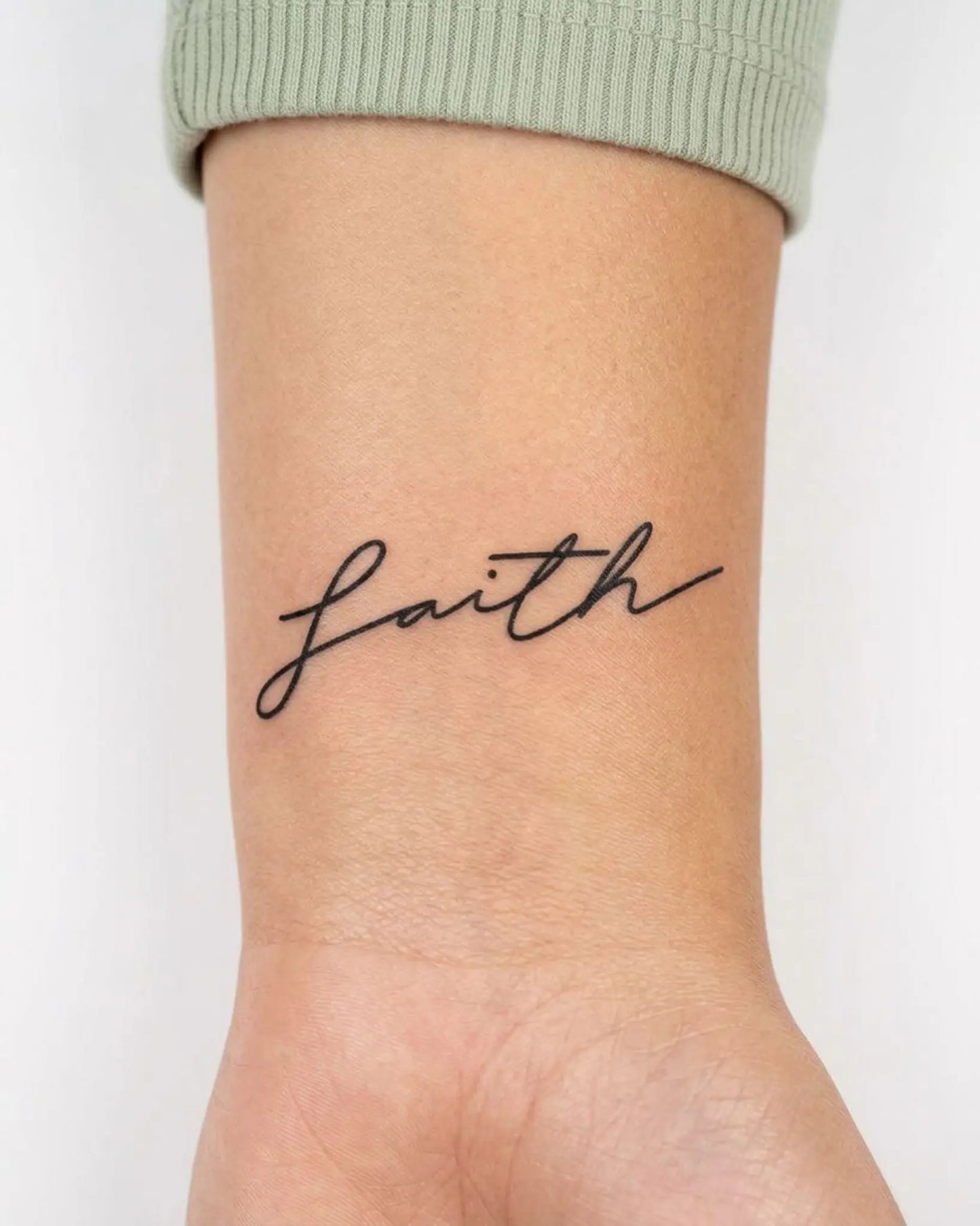 INKY Faith semi-permanent tattoo applied on a woman – 2 x 2 in (4x4 cm) design, realistic ink look, lasts 10 days