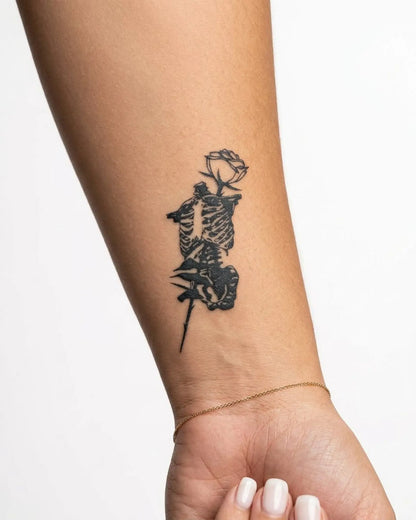 INKY Rose Skeleton semi-permanent tattoo applied on a woman – 2 x 4 in (6x10 cm) design, realistic ink look, lasts 10 days