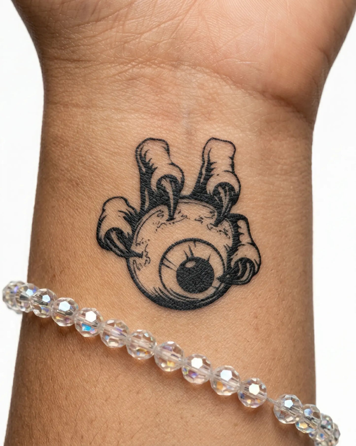 INKY Clawed Eye semi-permanent tattoo applied on a woman – 2 x 2 in (4x4 cm) design, realistic ink look, lasts 10 days
