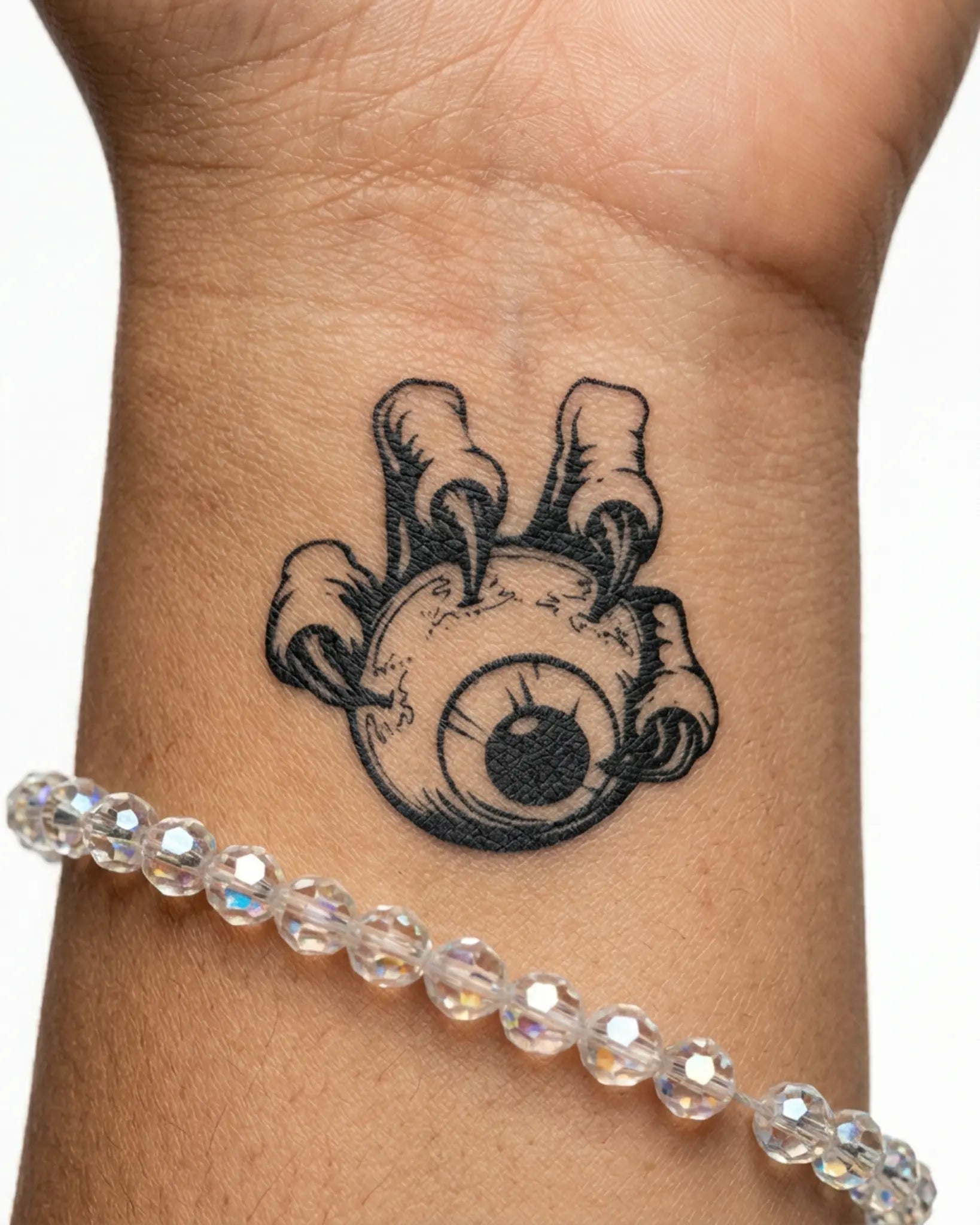 INKY Clawed Eye semi-permanent tattoo applied on a woman – 2 x 2 in (4x4 cm) design, realistic ink look, lasts 10 days