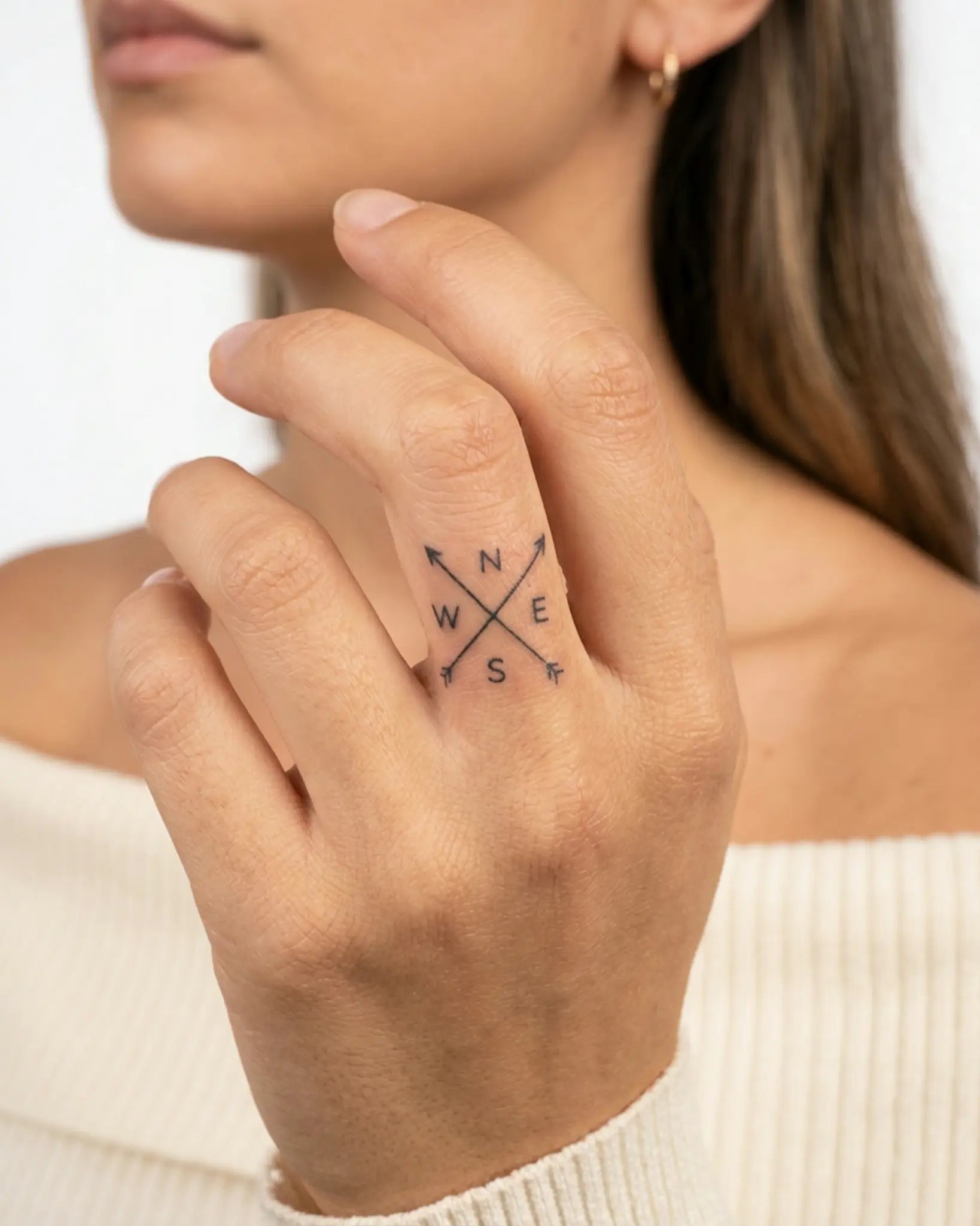 INKY NSEW Arrows semi-permanent tattoo applied on a woman – 0.5 x 0.5 in (1x1 cm) design, realistic ink look, lasts 10 days