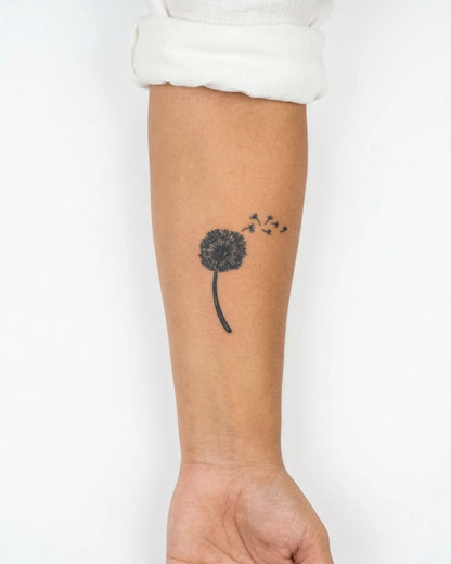 INKY Dandelion Wis semi-permanent tattoo applied on a woman – 3 x 4 in (7x10 cm) design, realistic ink look, lasts 10 days