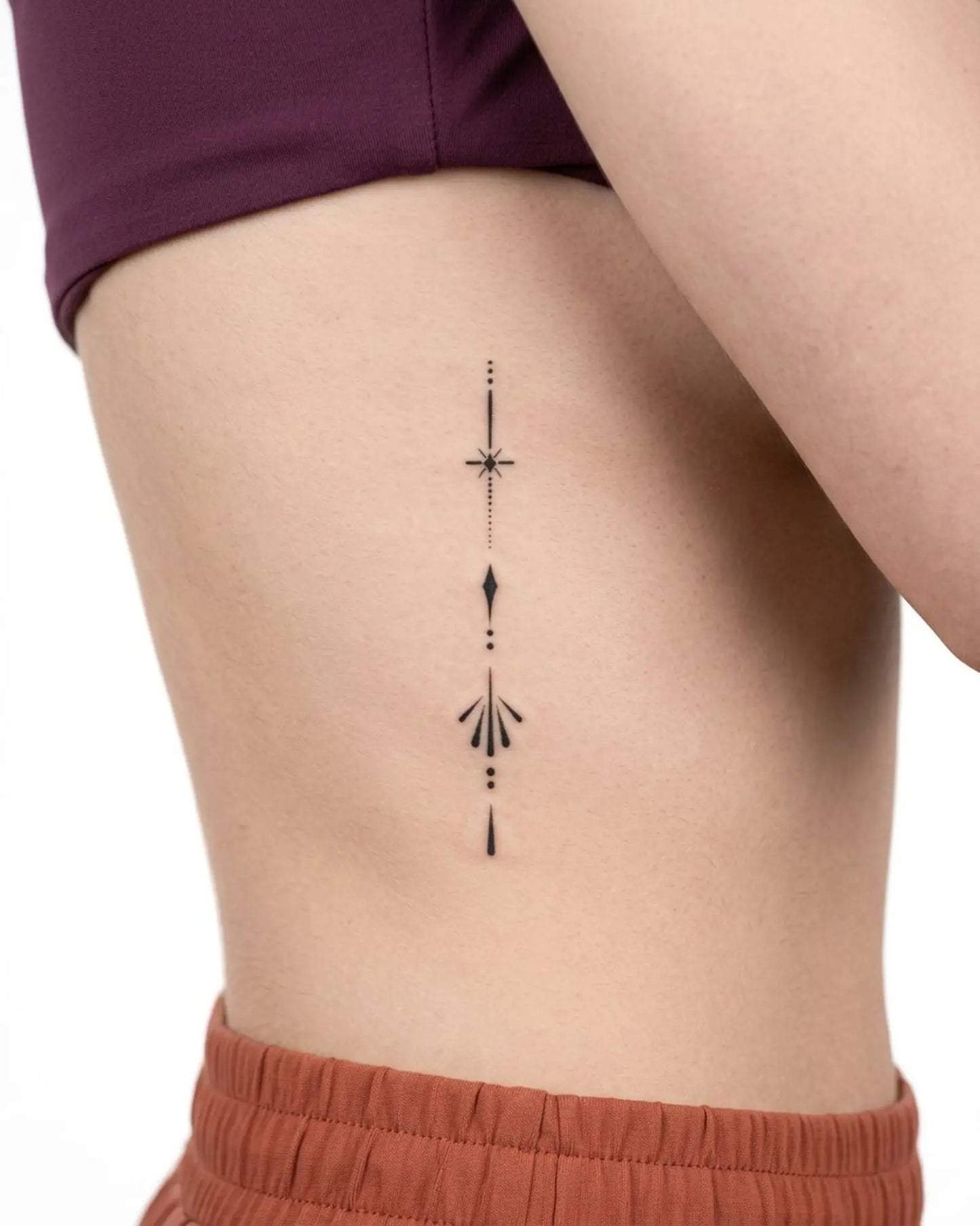 INKY Sleek Emblem semi-permanent tattoo applied on a woman – 2 x 4 in (6x10 cm) design, realistic ink look, lasts 10 days