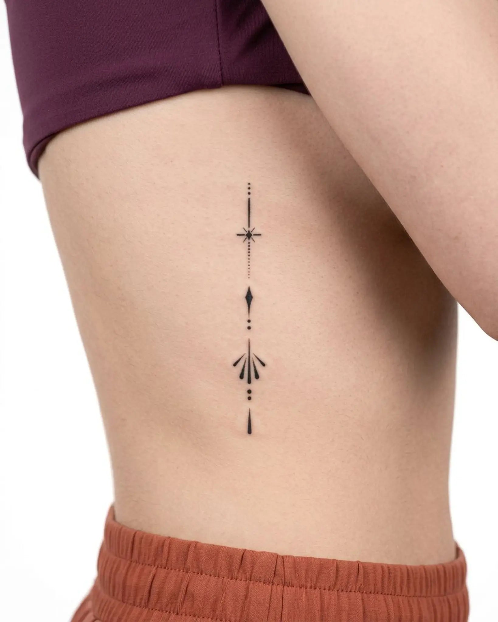 INKY Sleek Emblem semi-permanent tattoo applied on a woman – 2 x 4 in (6x10 cm) design, realistic ink look, lasts 10 days