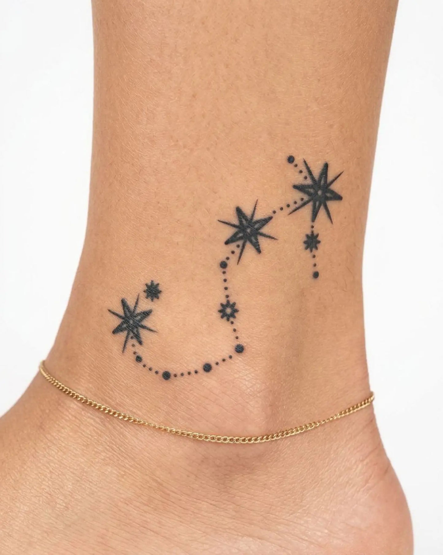 INKY Star Chain Scorpio semi-permanent tattoo applied on a woman – 2 x 2 in (4x4 cm) design, realistic ink look, lasts 10 days