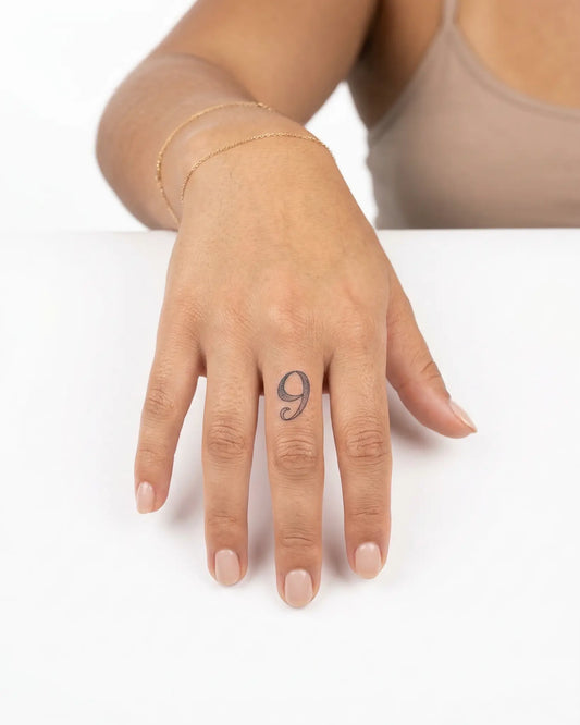 INKY Textured 9 semi-permanent tattoo applied on a woman – 0.5 x 0.5 in (1x1 cm) design, realistic ink look, lasts 10 days