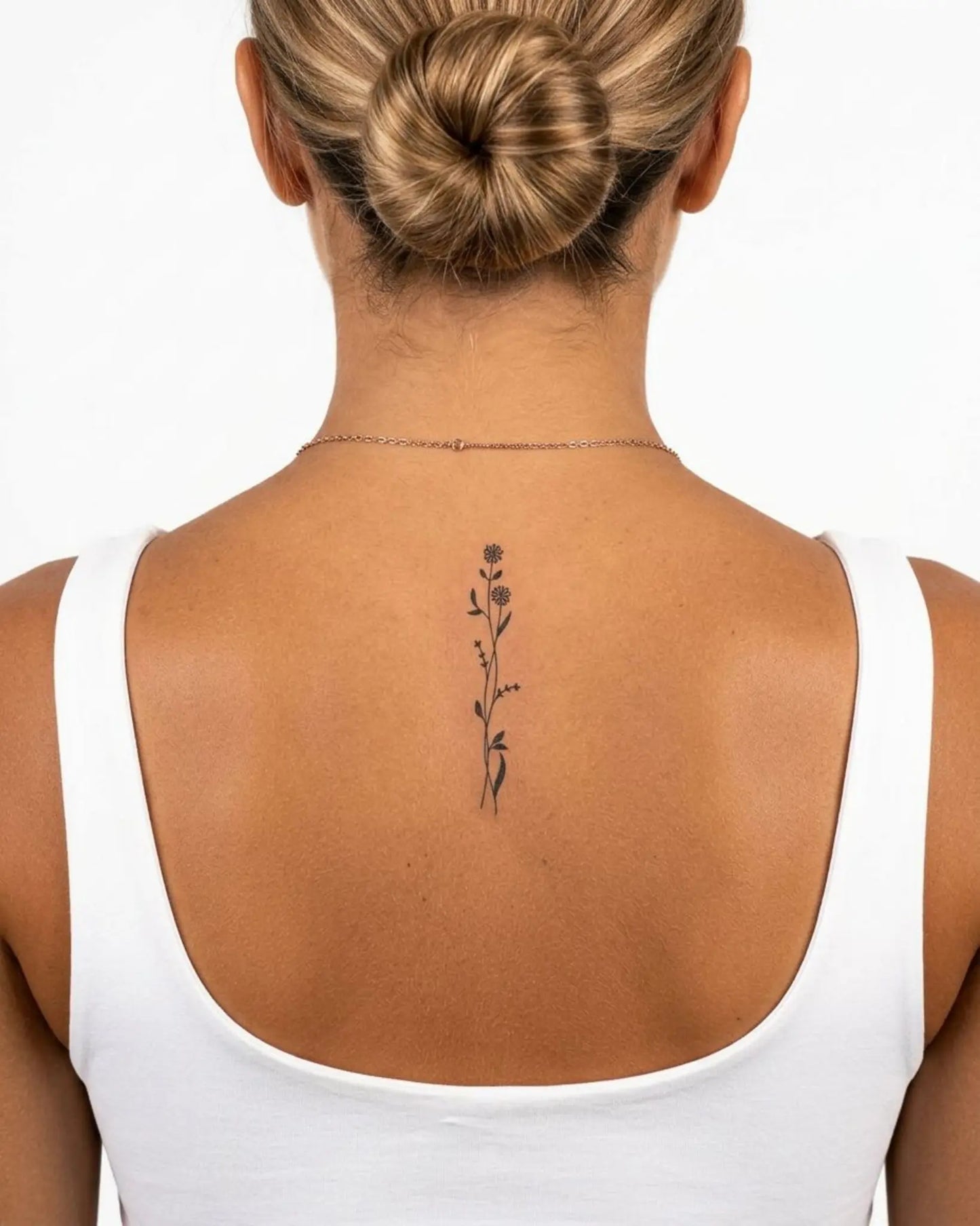 INKY Floral Stem 2 semi-permanent tattoo applied on a woman – 2 x 4 in (6x10 cm) design, realistic ink look, lasts 10 days
