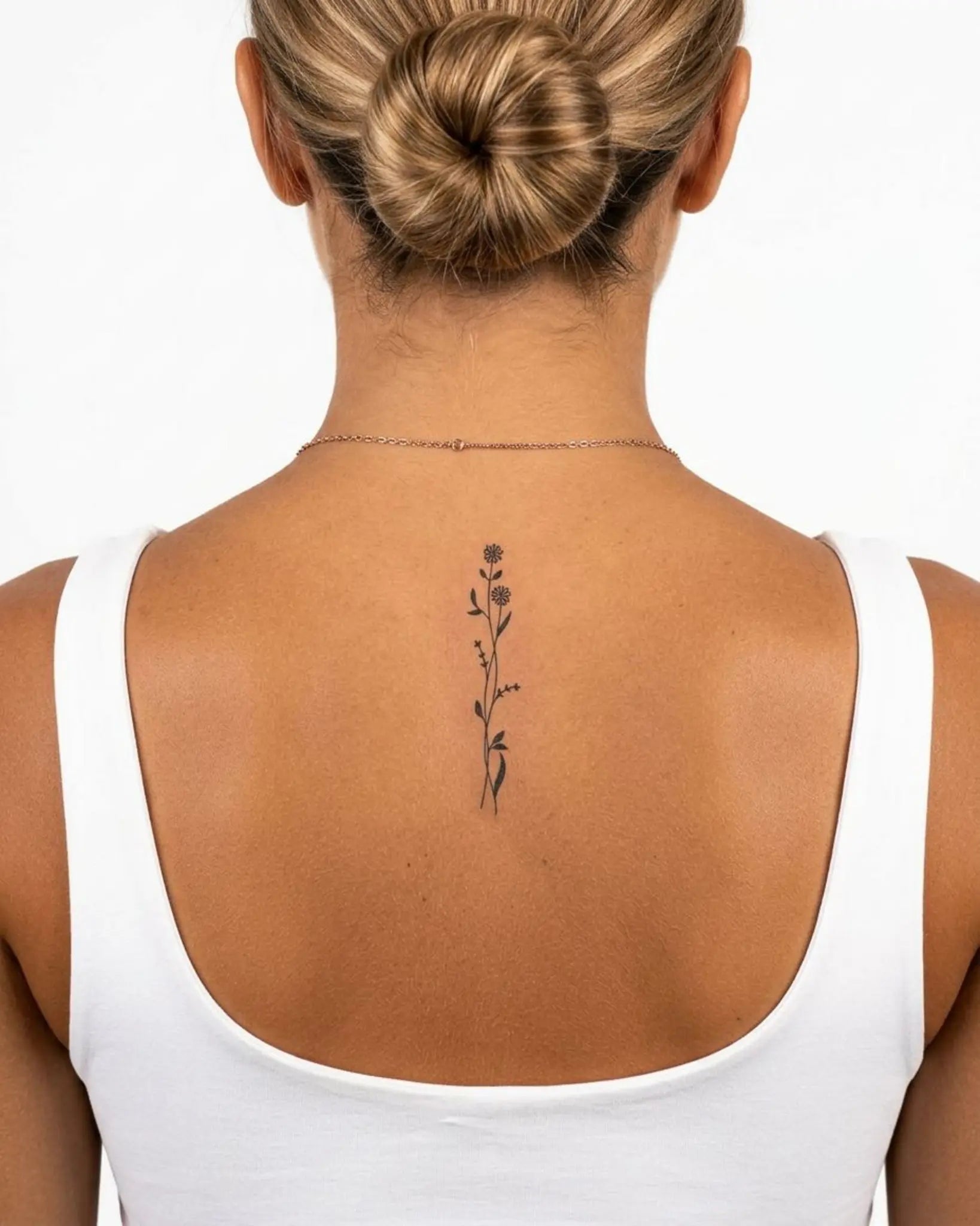 INKY Floral Stem 2 semi-permanent tattoo applied on a woman – 2 x 4 in (6x10 cm) design, realistic ink look, lasts 10 days