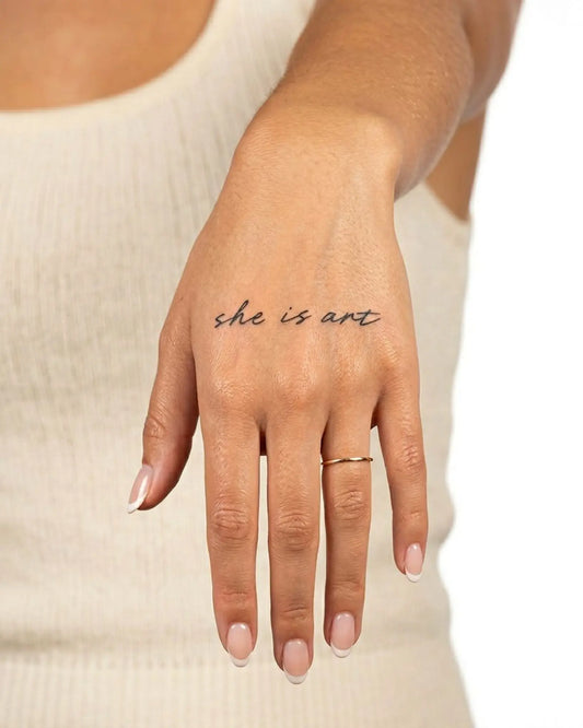 INKY She Is Art semi-permanent tattoo applied on a woman – 2 x 2 in (4x4 cm) design, realistic ink look, lasts 10 days