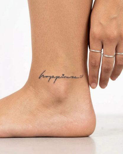 INKY Happiness semi-permanent tattoo applied on a woman – 2 x 2 in (4x4 cm) design, realistic ink look, lasts 10 days