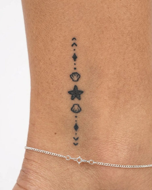 INKY Tidal Chain semi-permanent tattoo applied on a woman – 2 x 2 in (4x4 cm) design, realistic ink look, lasts 10 days