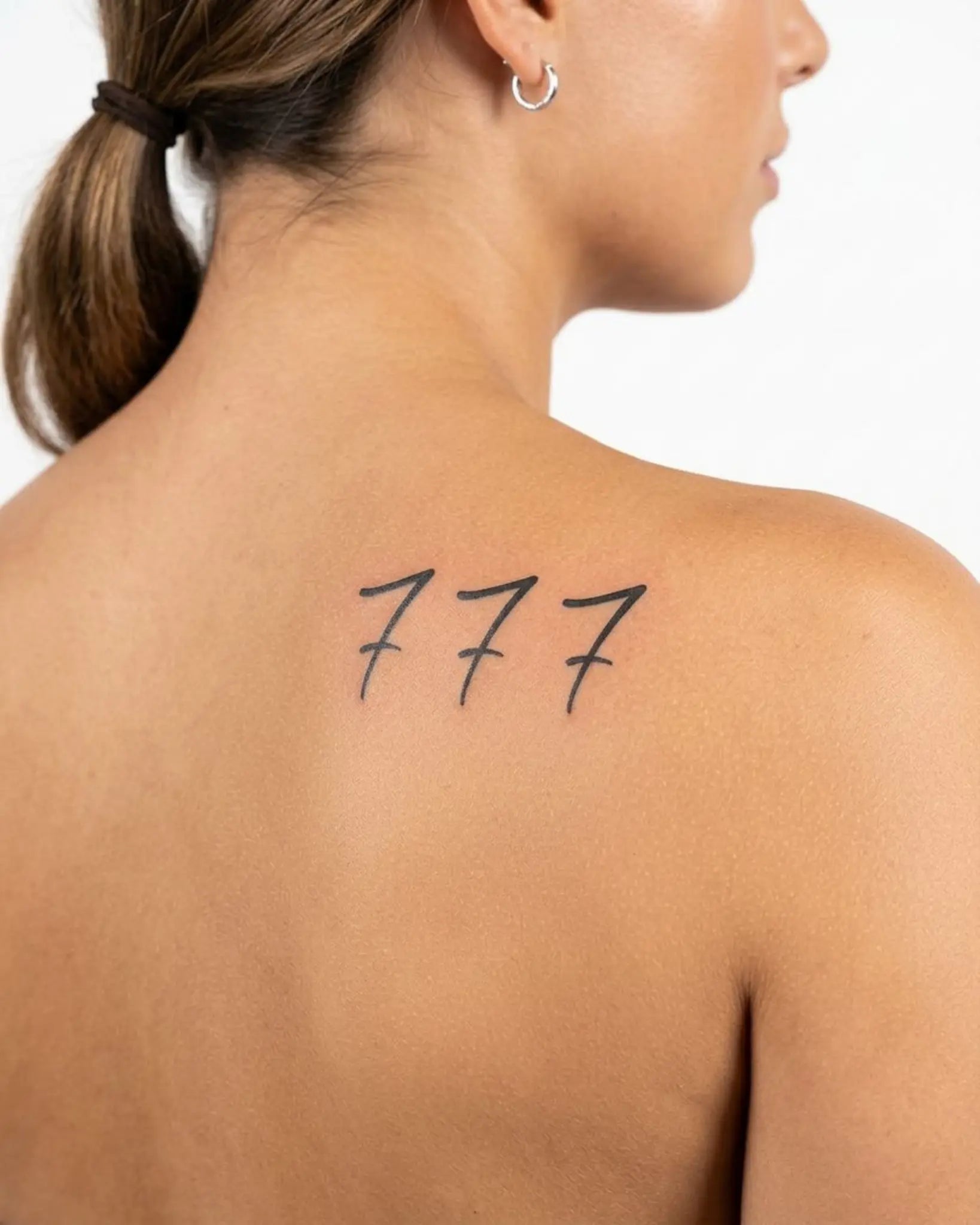 INKY Triple 7s 2 semi-permanent tattoo applied on a woman – 3 x 3 in (7x7 cm) design, realistic ink look, lasts 10 days