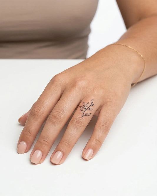 INKY Leafy Sprig semi-permanent tattoo applied on a woman – 0.5 x 0.5 in (1x1 cm) design, realistic ink look, lasts 10 days