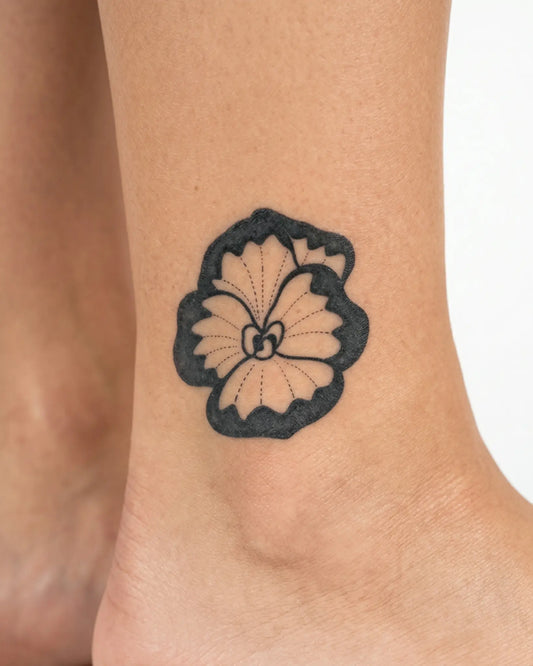 INKY Pansy Bloom semi-permanent tattoo applied on a woman – 2 x 2 in (4x4 cm) design, realistic ink look, lasts 10 days