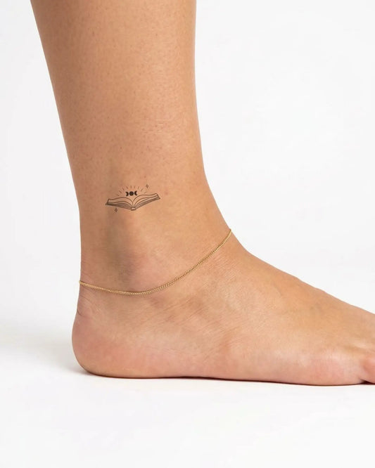 INKY Spell Book semi-permanent tattoo applied on a woman – 2 x 2 in (4x4 cm) design, realistic ink look, lasts 10 days