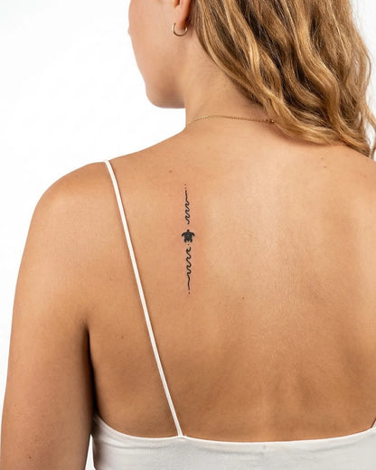 INKY Turtle Path semi-permanent tattoo applied on a woman – 2 x 4 in (6x10 cm) design, realistic ink look, lasts 10 days