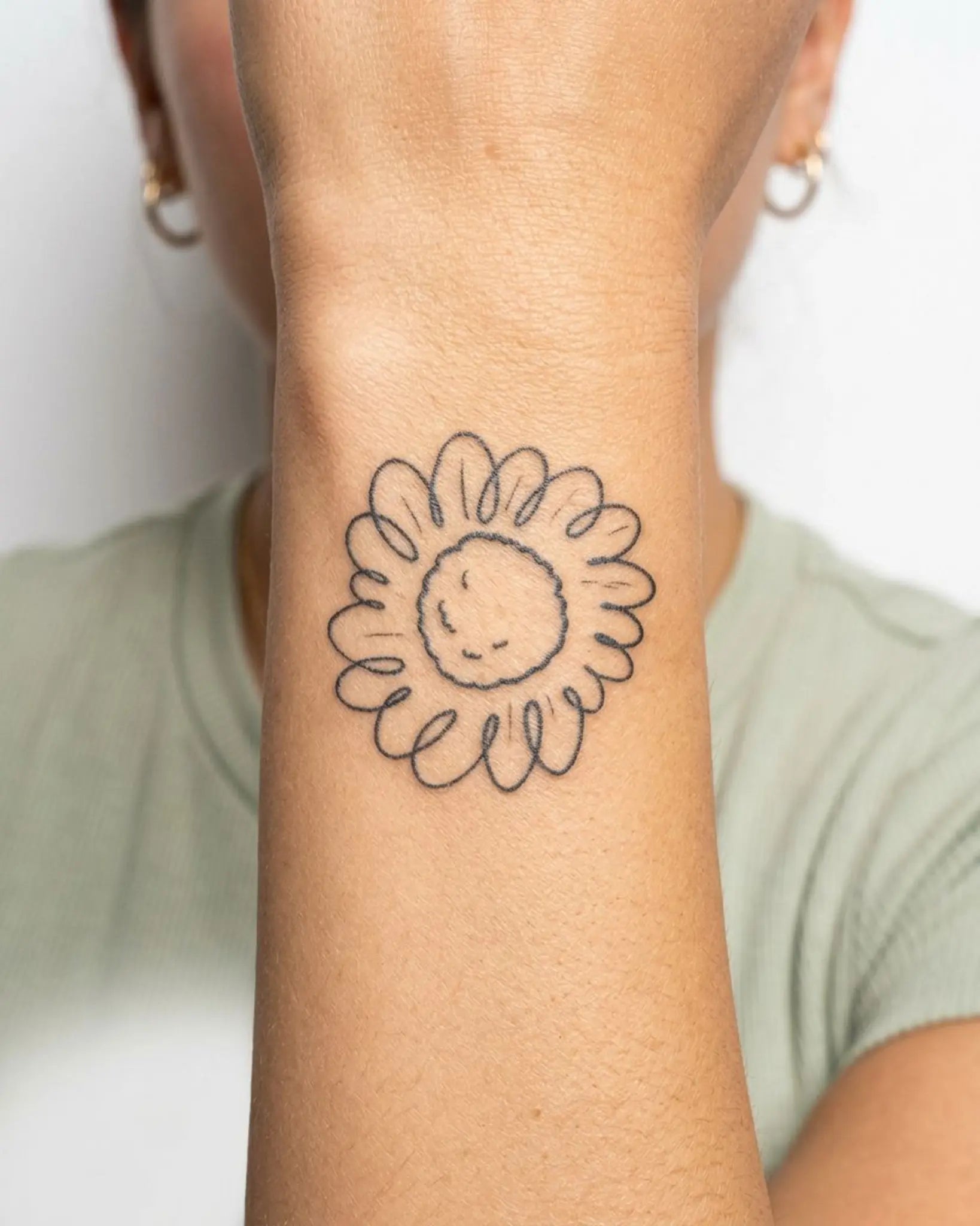 INKY Doodle Sun semi-permanent tattoo applied on a woman – 2 x 2 in (4x4 cm) design, realistic ink look, lasts 10 days