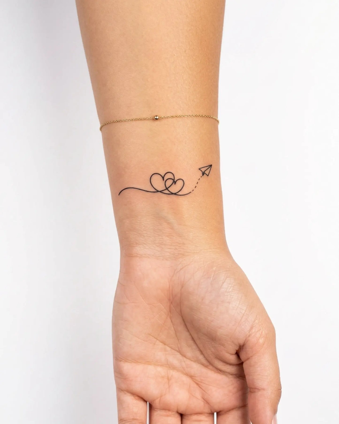 INKY Love Flight semi-permanent tattoo applied on a woman – 2 x 2 in (4x4 cm) design, realistic ink look, lasts 10 days