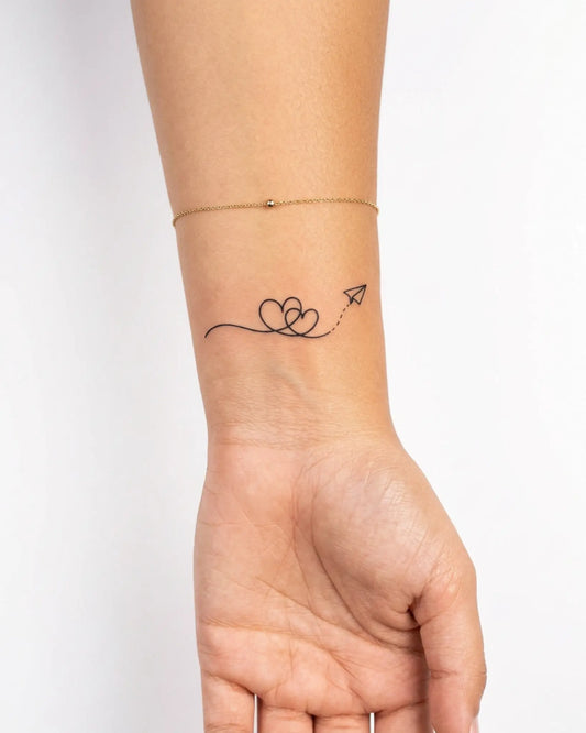 INKY Love Flight semi-permanent tattoo applied on a woman – 2 x 2 in (4x4 cm) design, realistic ink look, lasts 10 days