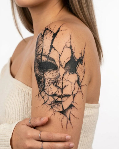 INKY Cracked Mask semi-permanent tattoo applied on a woman – 4 x 7 in (10x17 cm) design, realistic ink look, lasts 10 days