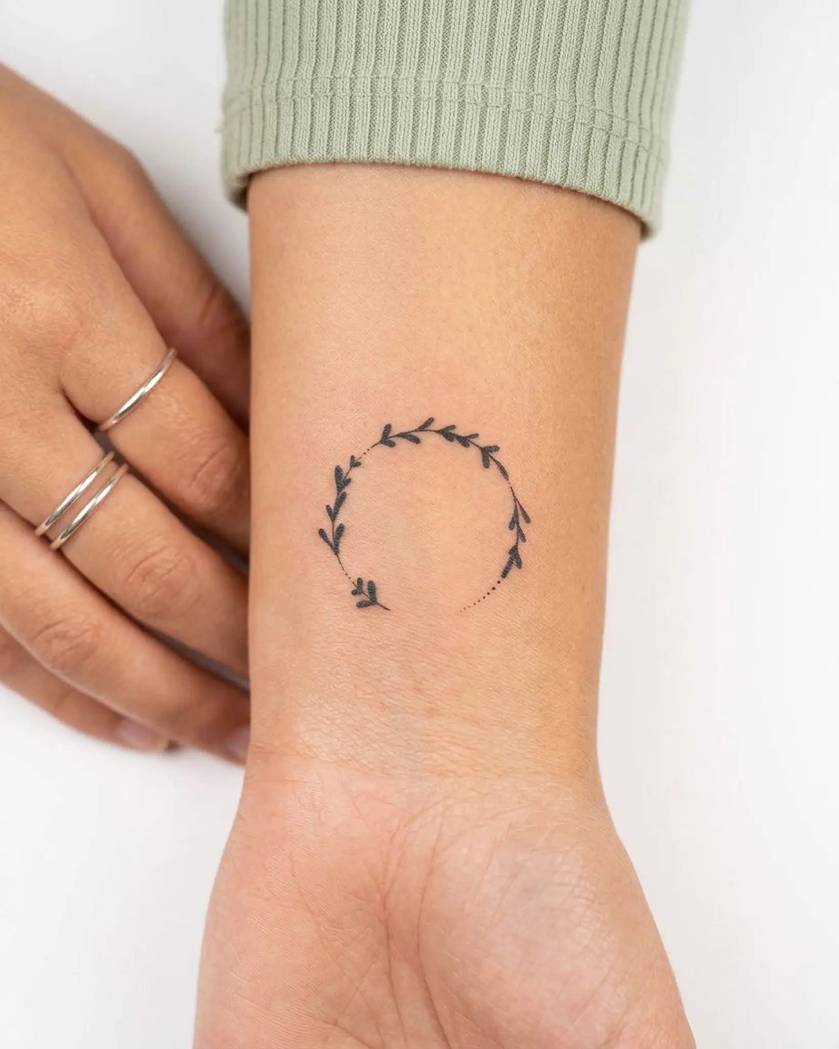 INKY Leaf Wreath semi-permanent tattoo applied on a woman – 2 x 2 in (4x4 cm) design, realistic ink look, lasts 10 days