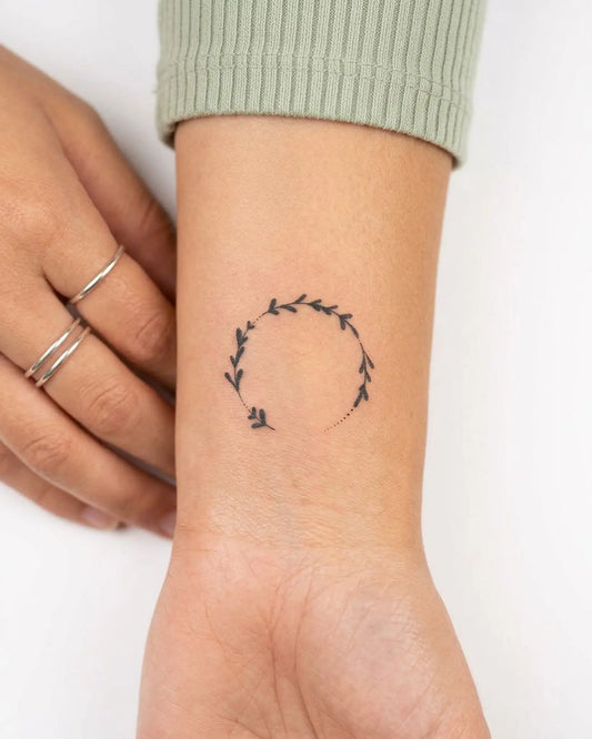 INKY Leaf Wreath semi-permanent tattoo applied on a woman – 2 x 2 in (4x4 cm) design, realistic ink look, lasts 10 days