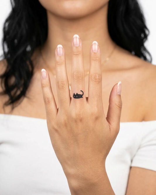 INKY Black Kitty semi-permanent tattoo applied on a woman – 0.5 x 0.5 in (1x1 cm) design, realistic ink look, lasts 10 days