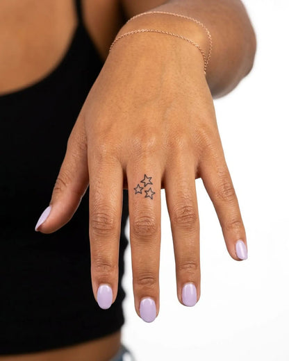 INKY Star Trio semi-permanent tattoo applied on a woman – 0.5 x 0.5 in (1x1 cm) design, realistic ink look, lasts 10 days