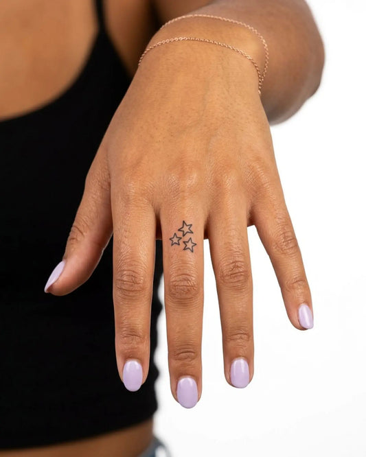 INKY Star Trio semi-permanent tattoo applied on a woman – 0.5 x 0.5 in (1x1 cm) design, realistic ink look, lasts 10 days