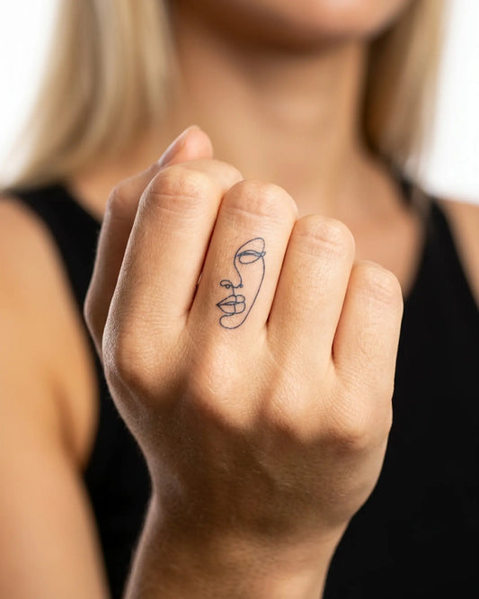 INKY Line Art Face semi-permanent tattoo applied on a woman – 0.5 x 0.5 in (1x1 cm) design, realistic ink look, lasts 10 days