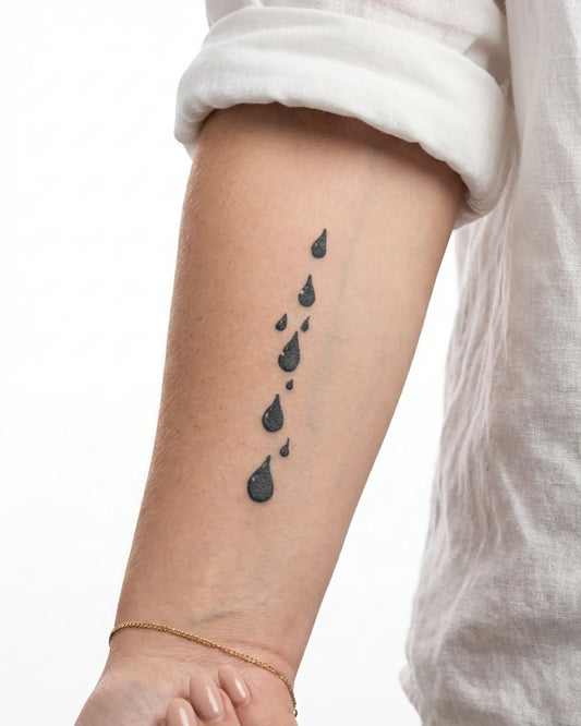 INKY Droplets semi-permanent tattoo applied on a woman – 2 x 4 in (6x10 cm) design, realistic ink look, lasts 10 days