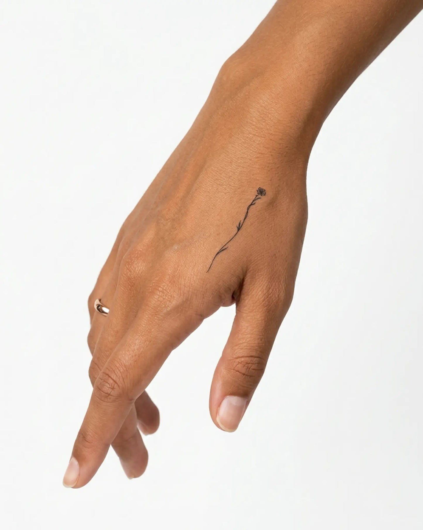 INKY Tall Bloom semi-permanent tattoo applied on a woman – 2 x 2 in (4x4 cm) design, realistic ink look, lasts 10 days