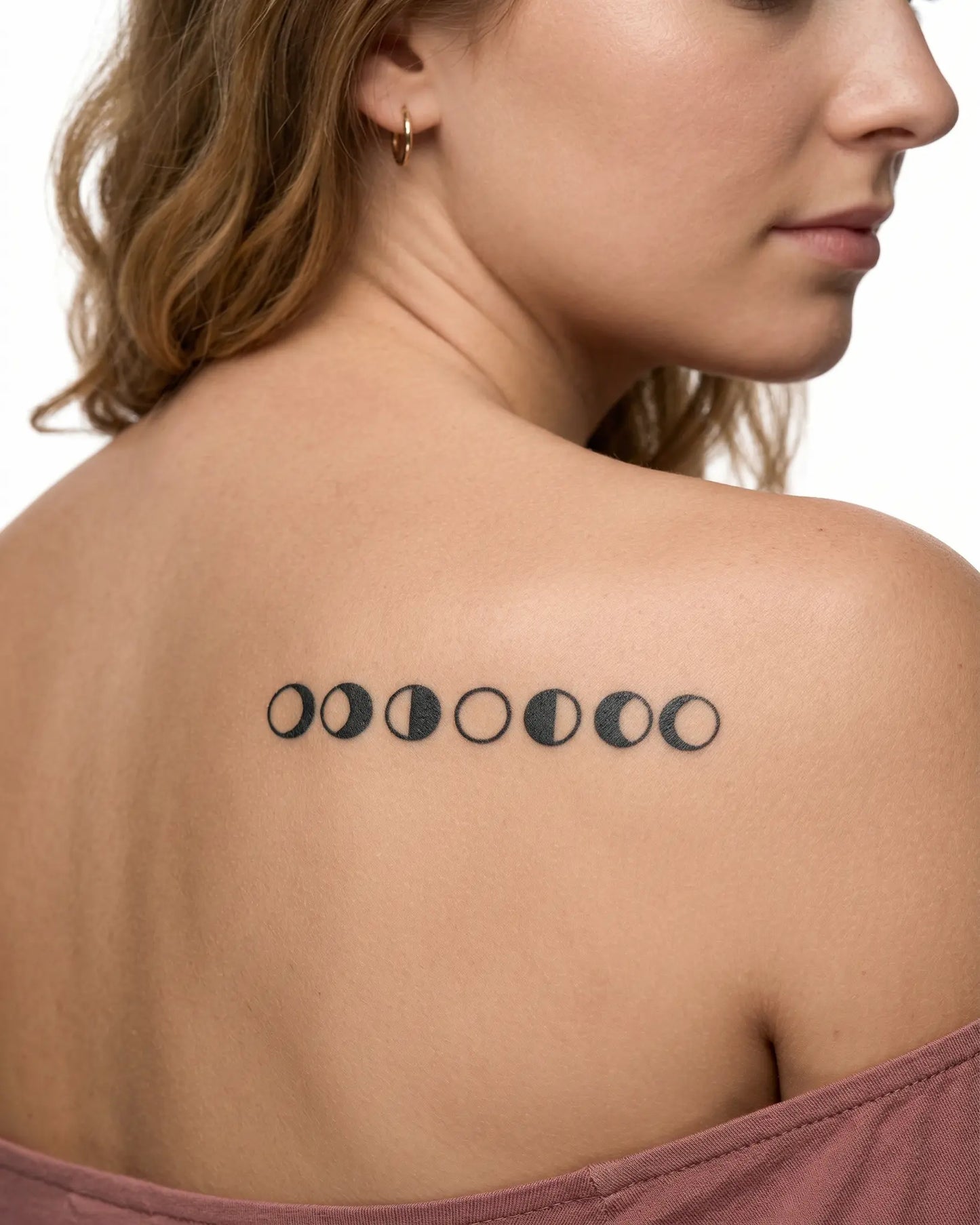 INKY Moon Phases semi-permanent tattoo applied on a woman – 2 x 4 in (6x10 cm) design, realistic ink look, lasts 10 days