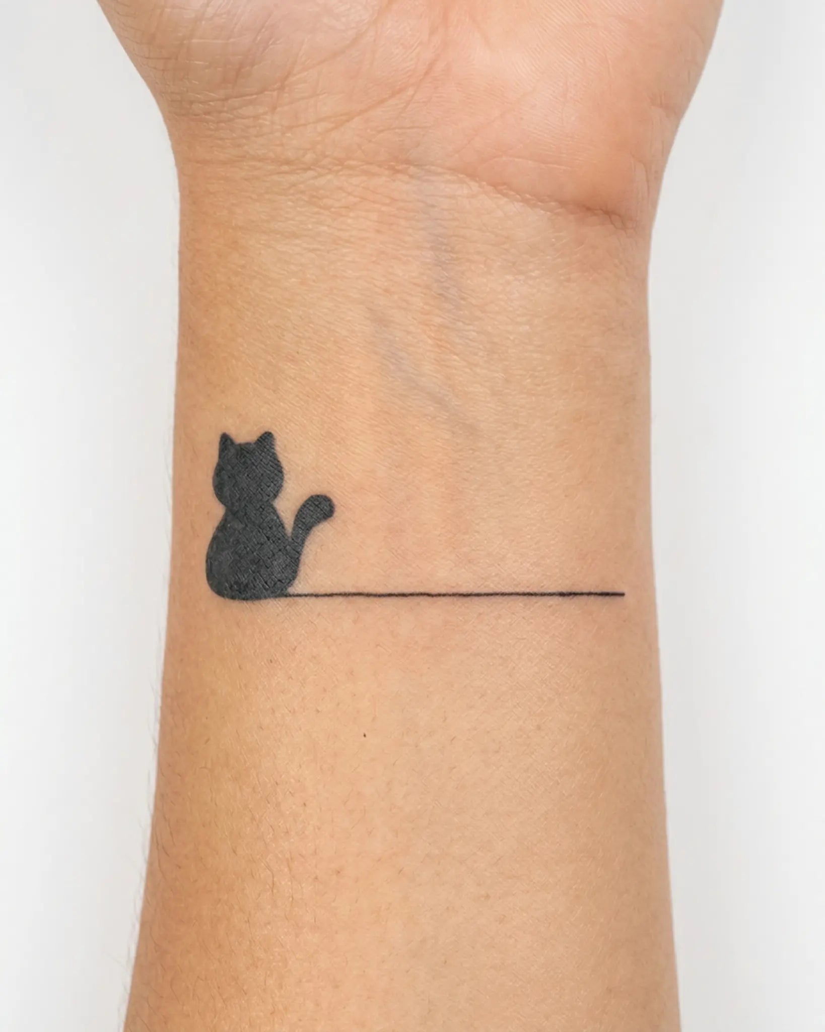 INKY Minimal Cat semi-permanent tattoo applied on a woman – 2 x 2 in (4x4 cm) design, realistic ink look, lasts 10 days