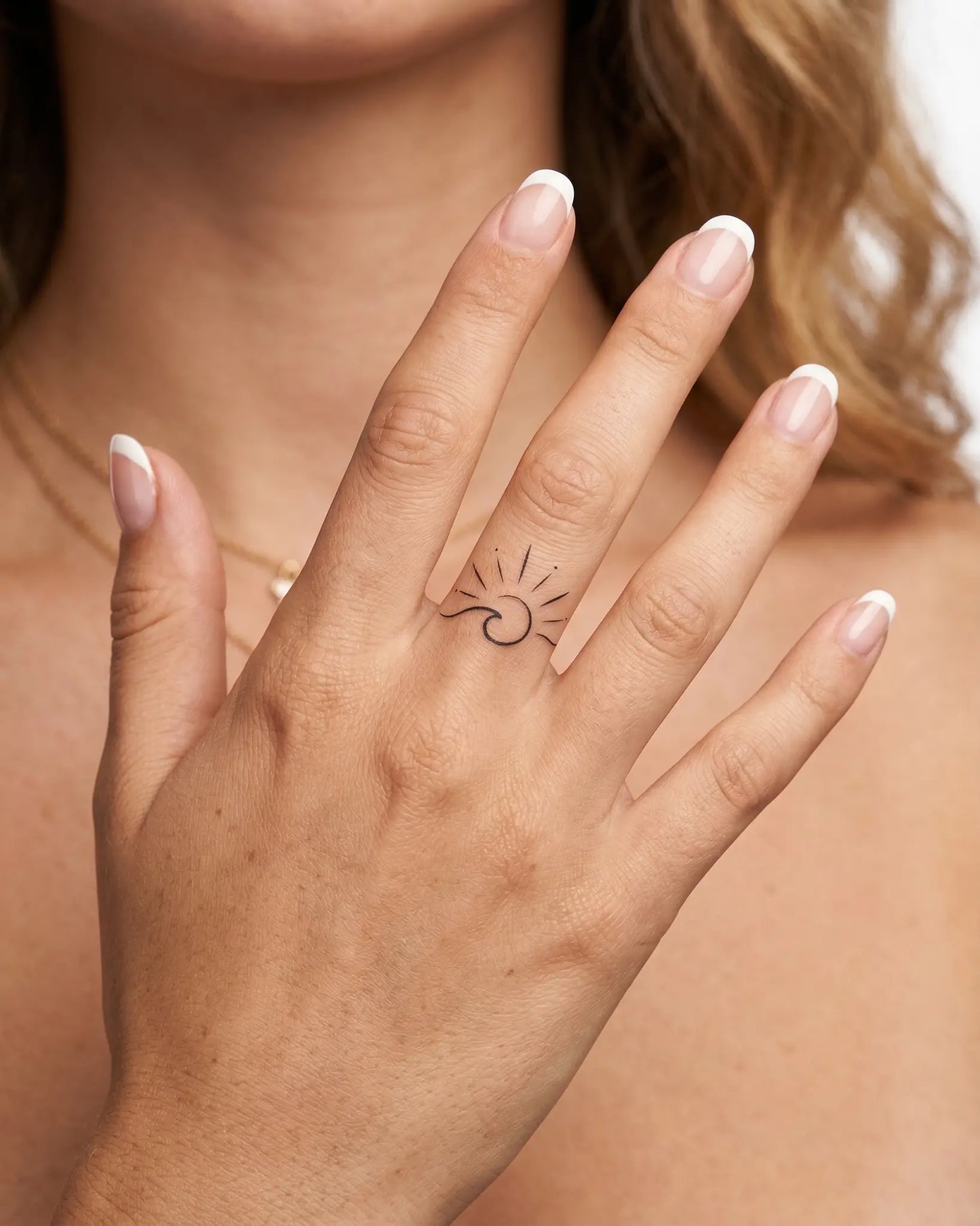 INKY Sun Wave semi-permanent tattoo applied on a woman – 0.5 x 0.5 in (1x1 cm) design, realistic ink look, lasts 10 days