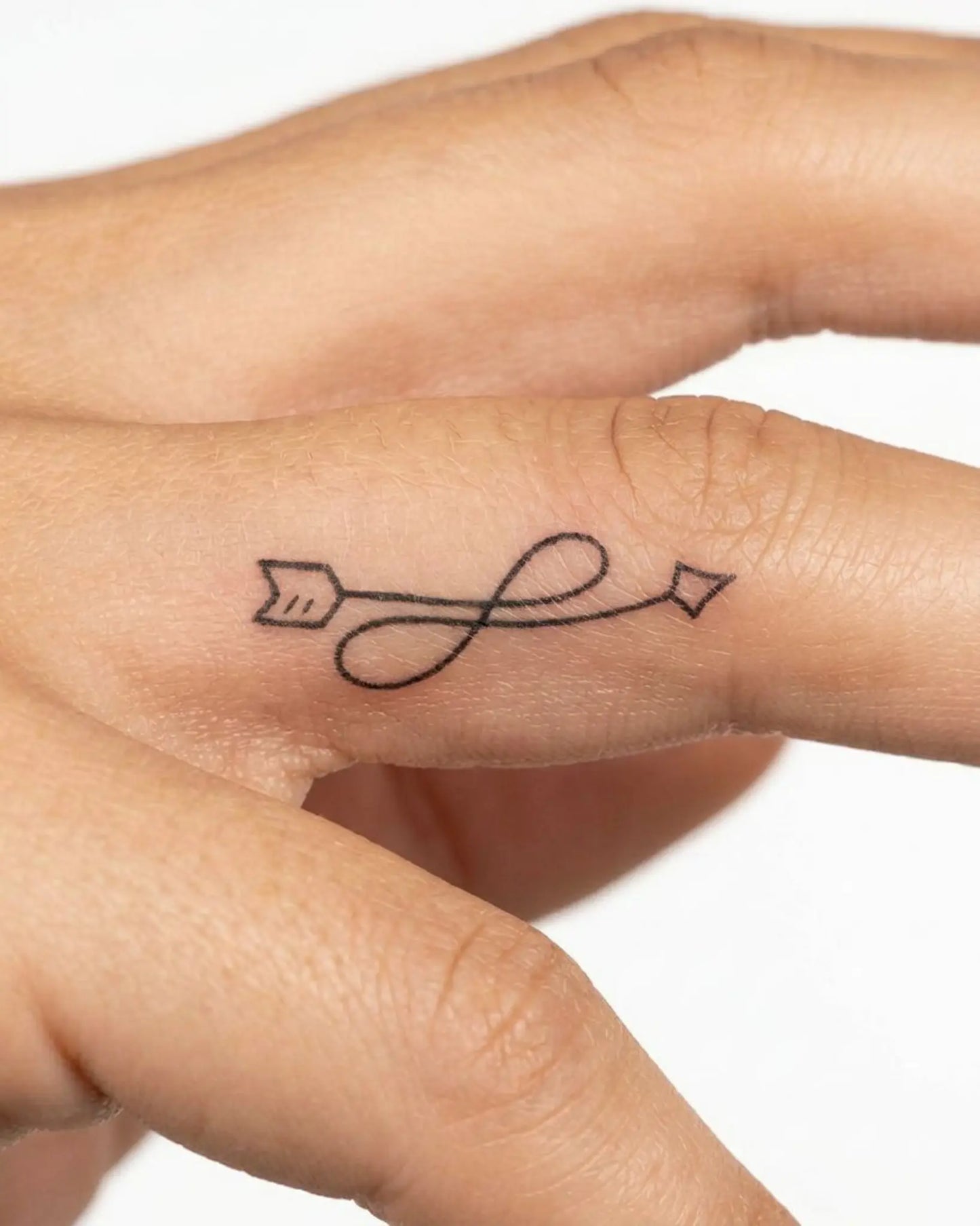 INKY Infinity Arro semi-permanent tattoo applied on a woman – 0.5 x 0.5 in (1x1 cm) design, realistic ink look, lasts 10 days