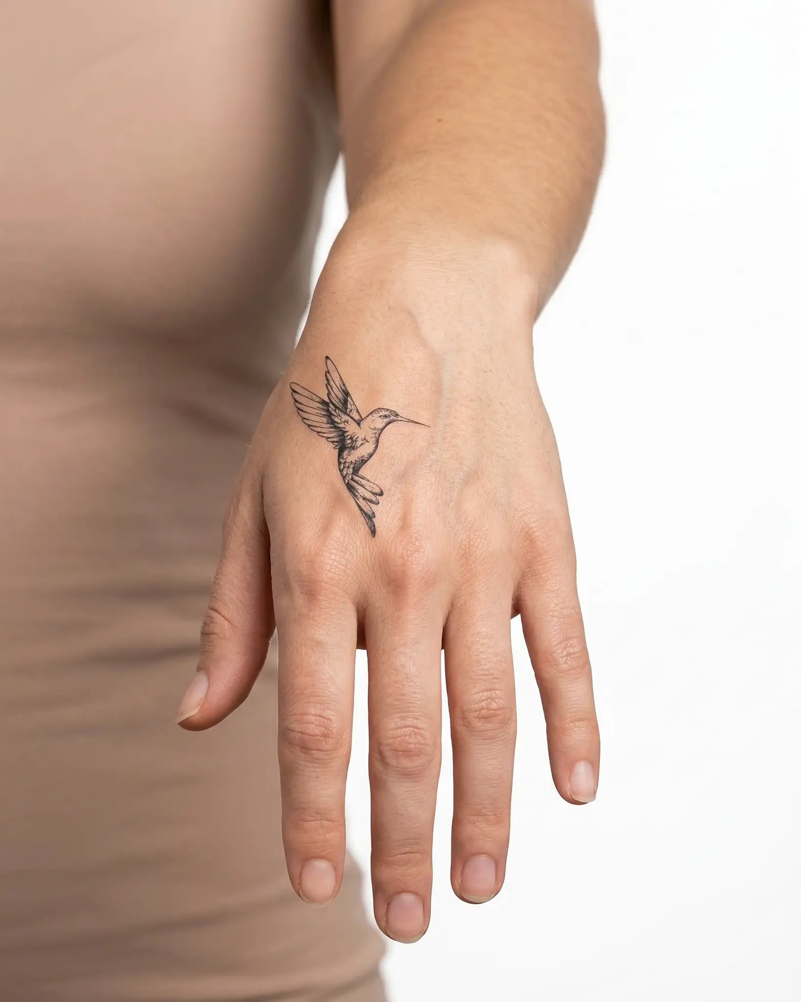 INKY Hummingbird 3 semi-permanent tattoo applied on a woman – 2 x 2 in (4x4 cm) design, realistic ink look, lasts 10 days