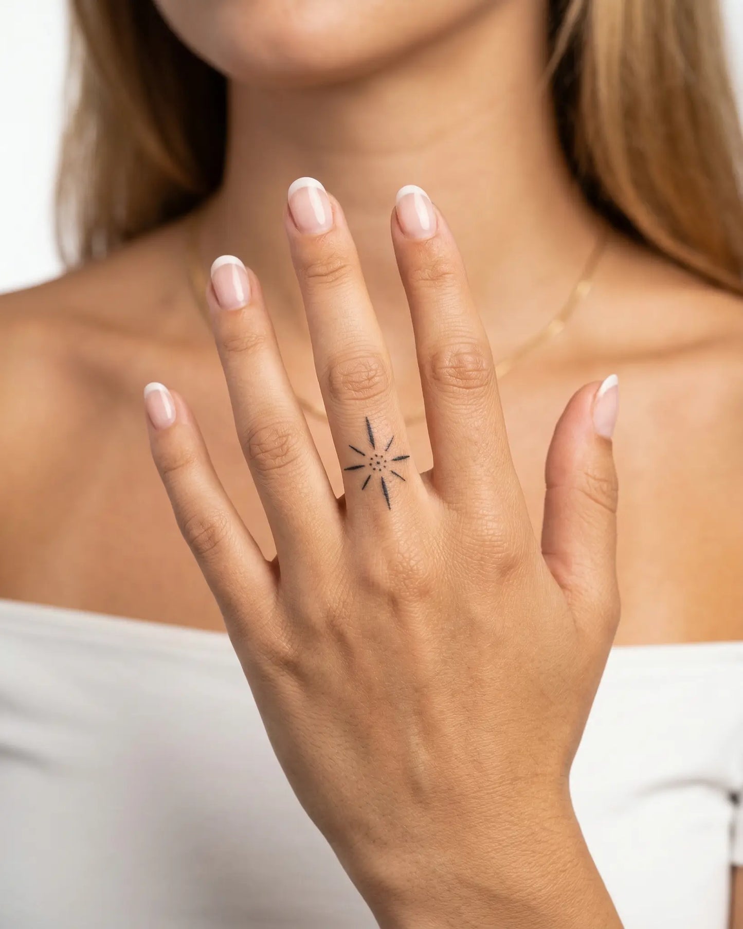 INKY Starburst semi-permanent tattoo applied on a woman – 0.5 x 0.5 in (1x1 cm) design, realistic ink look, lasts 10 days