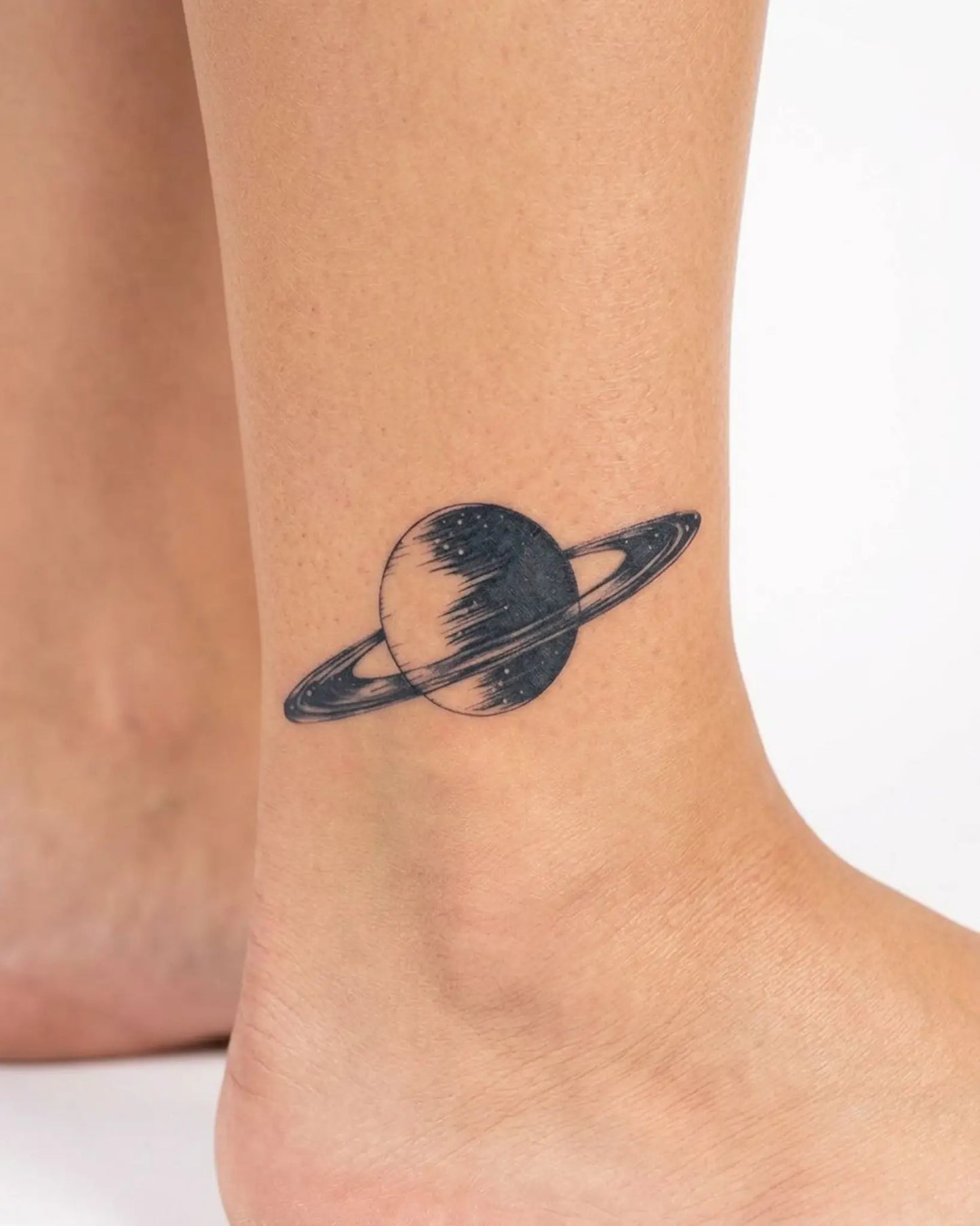 INKY Saturn semi-permanent tattoo applied on a woman – 2 x 2 in (4x4 cm) design, realistic ink look, lasts 10 days
