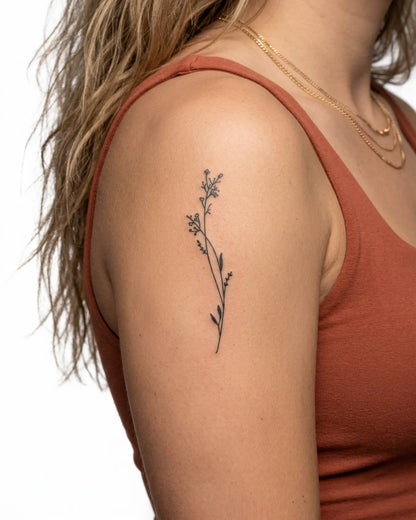 INKY Meadow Stem semi-permanent tattoo applied on a woman – 2 x 4 in (6x10 cm) design, realistic ink look, lasts 10 days