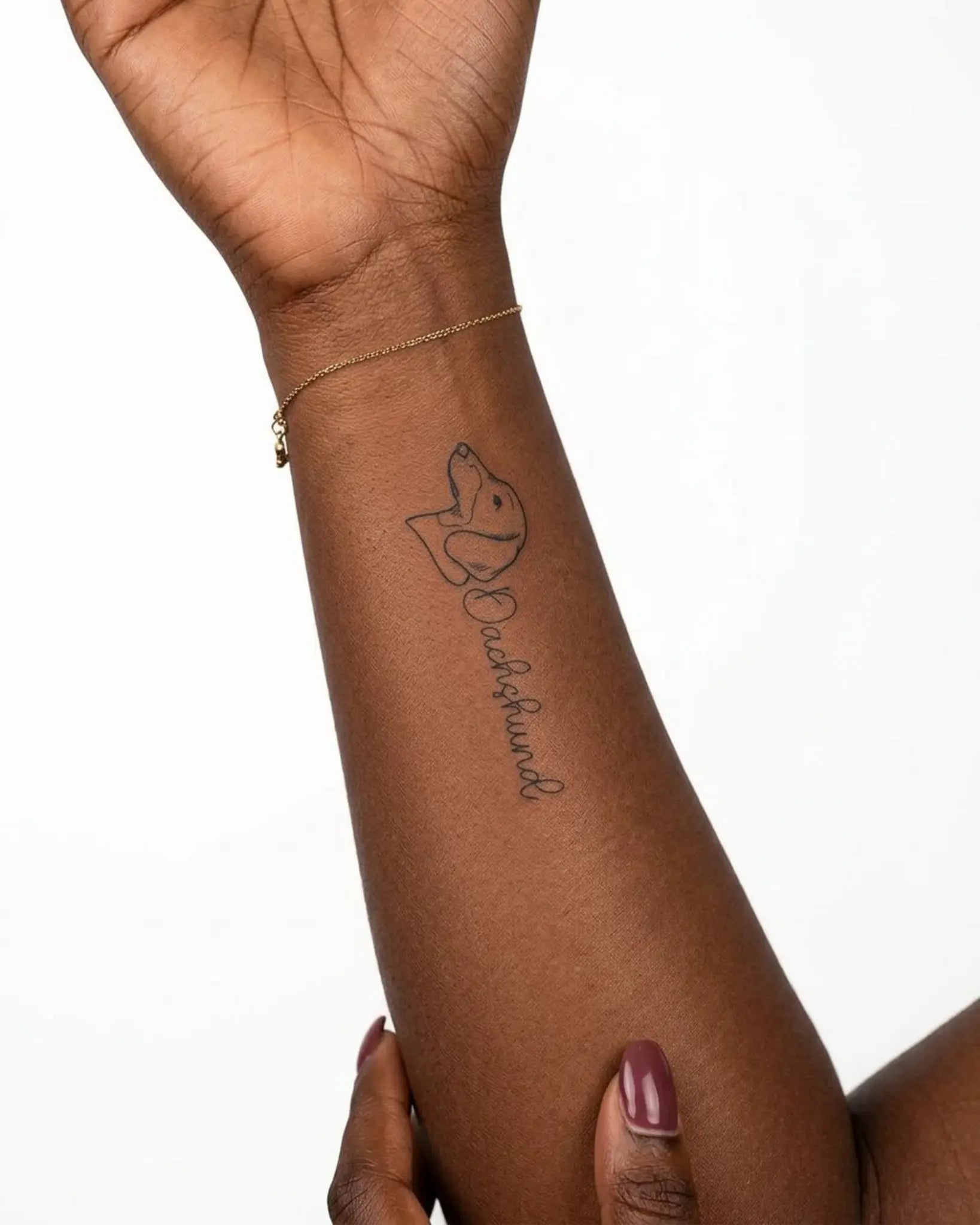 INKY Dachshund semi-permanent tattoo applied on a woman – 2 x 4 in (6x10 cm) design, realistic ink look, lasts 10 days