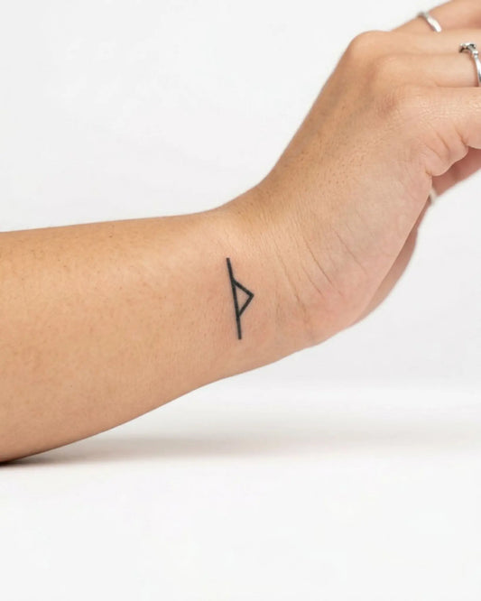 INKY Victory Rune semi-permanent tattoo applied on a woman – 0.5 x 0.5 in (1x1 cm) design, realistic ink look, lasts 10 days