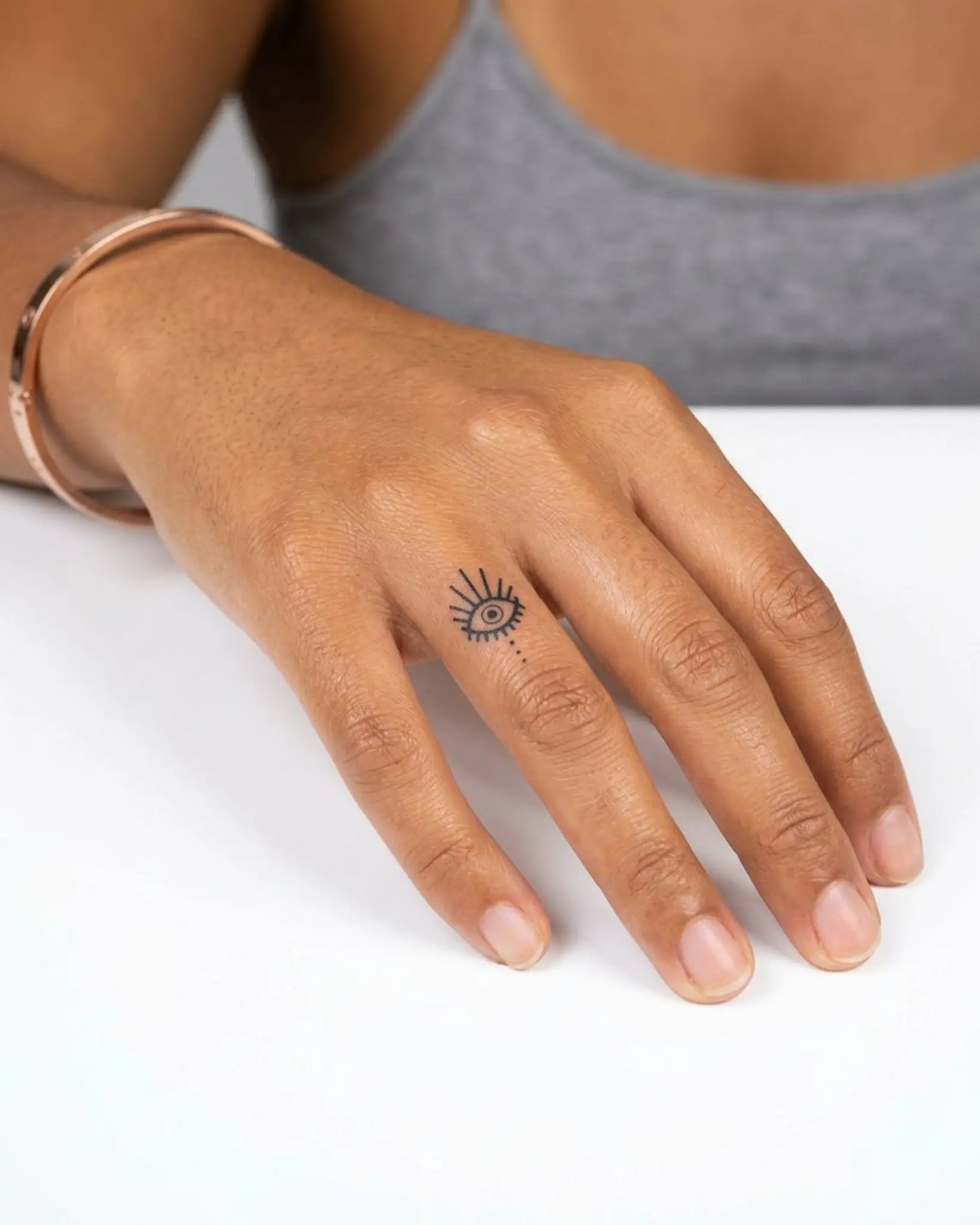 INKY Protective Ey semi-permanent tattoo applied on a woman – 0.5 x 0.5 in (1x1 cm) design, realistic ink look, lasts 10 days